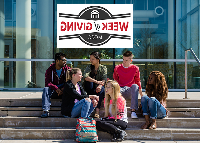 Group of students sitting in front of college hall